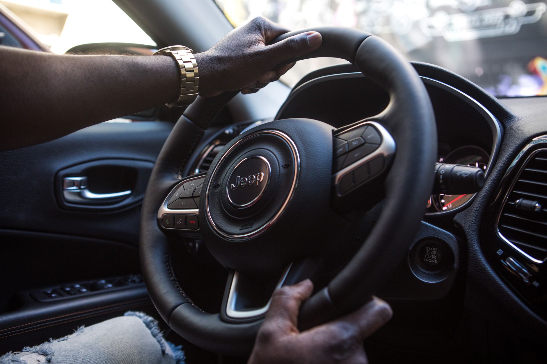 Hands on a steering wheel from the driver's seat
