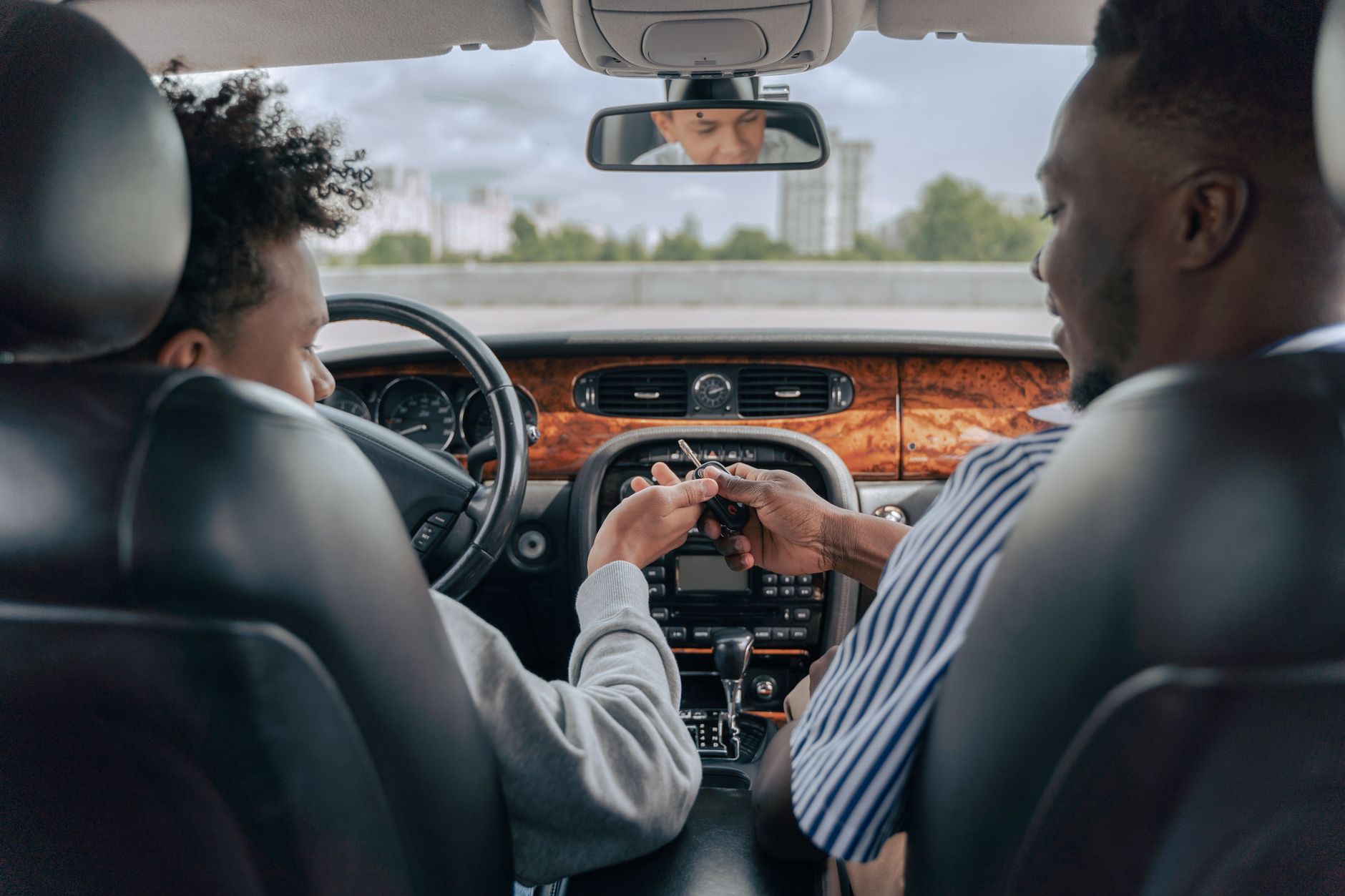 An instructor sitting in the passenger seat beside a learner driver during a lesson