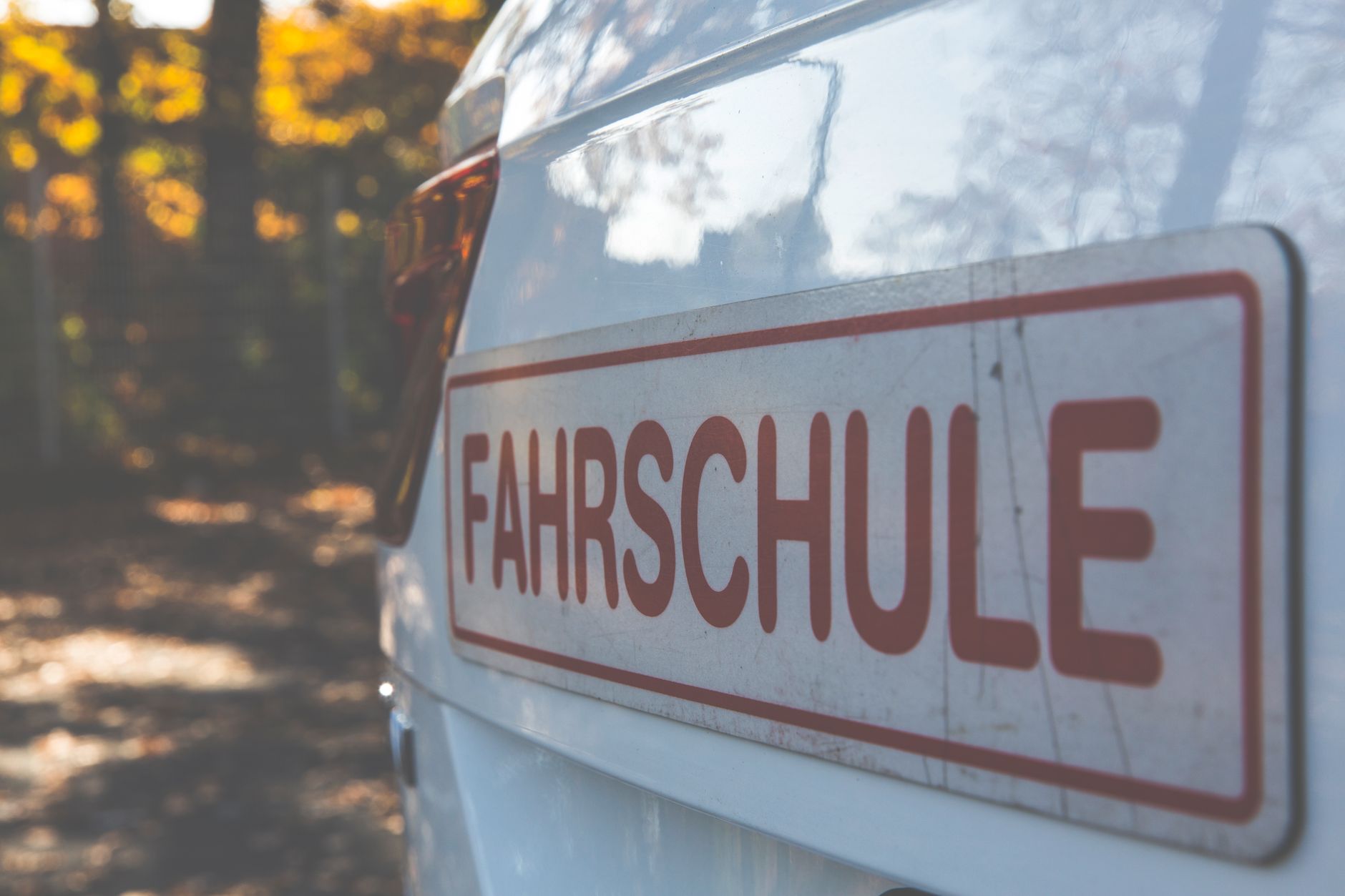 A driving school car parked at the kerb