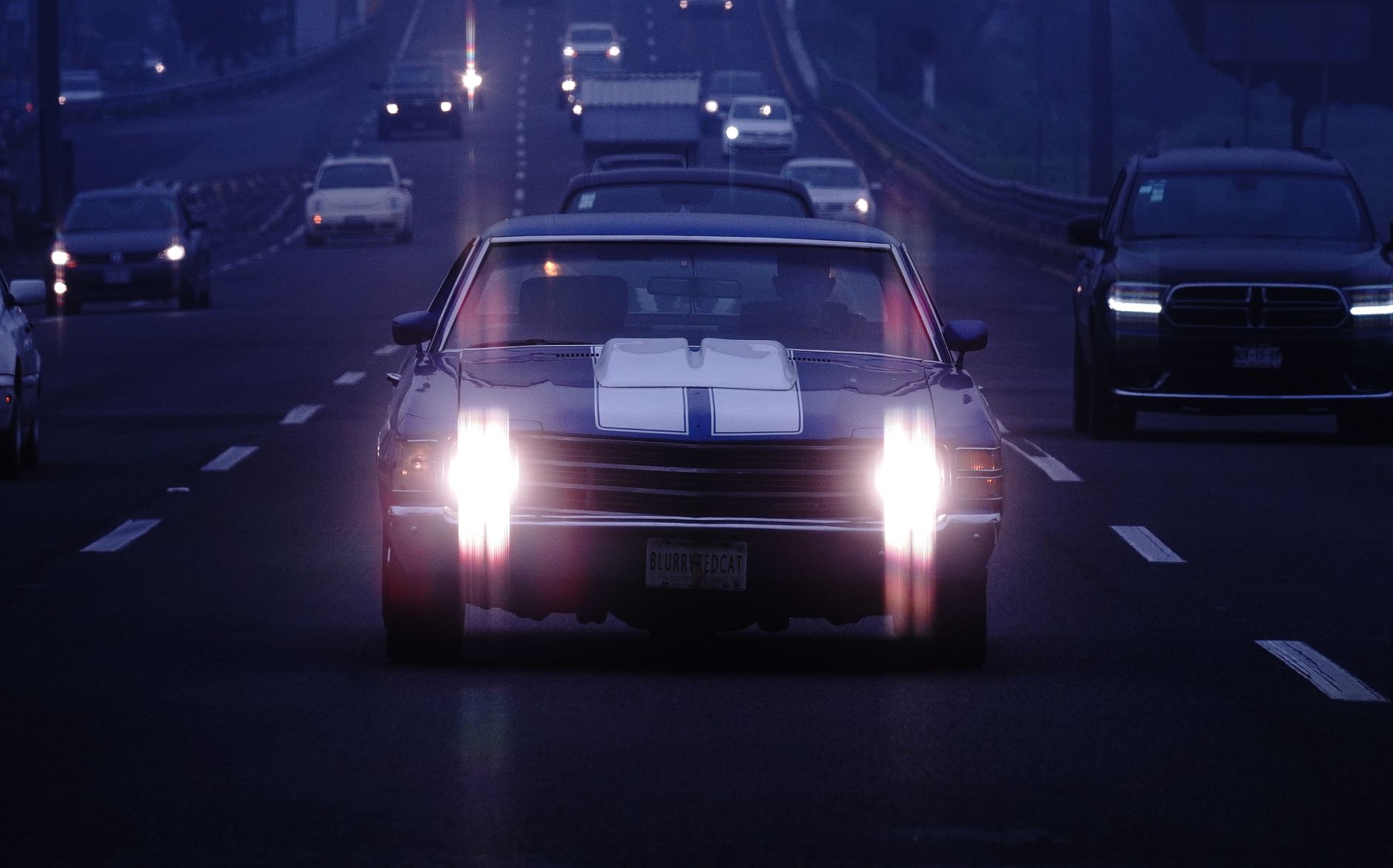 A car's headlights on a dark road at night