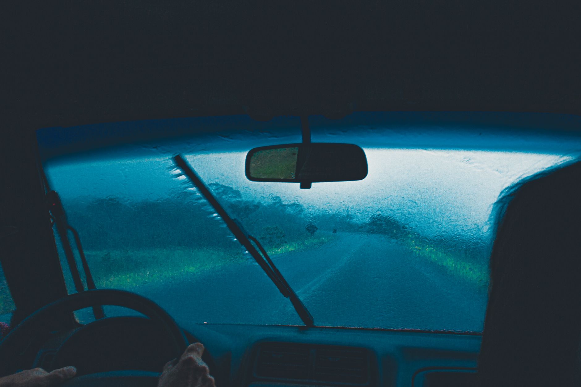 View through a rain-covered windscreen while driving