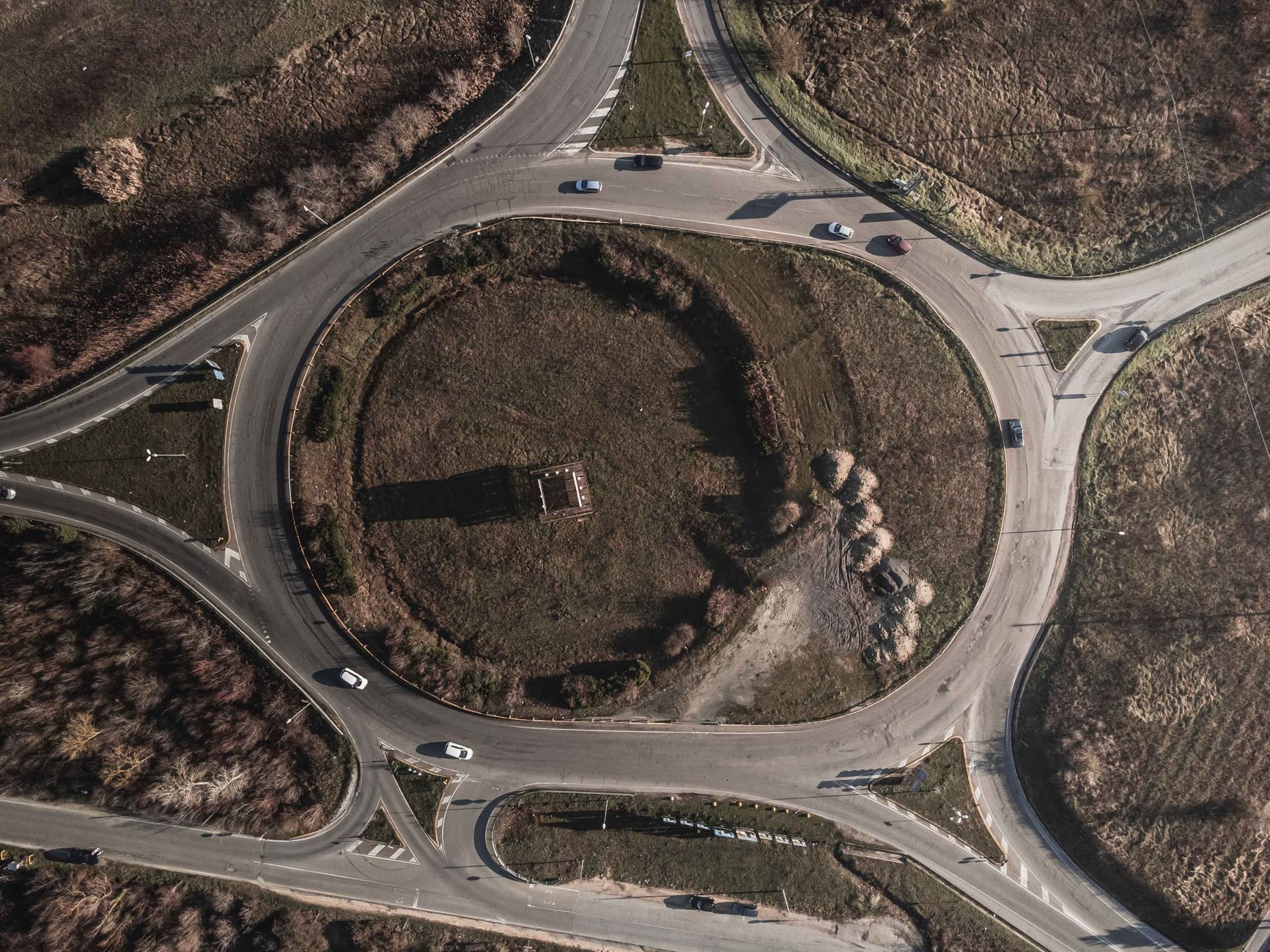 An aerial view of a roundabout with lanes marked and traffic flowing